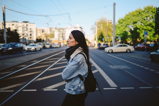 Young woman walking through the streets of Berlin, Germany.