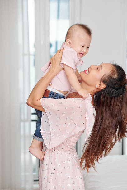 istock Mother lifting her little son 1257136943