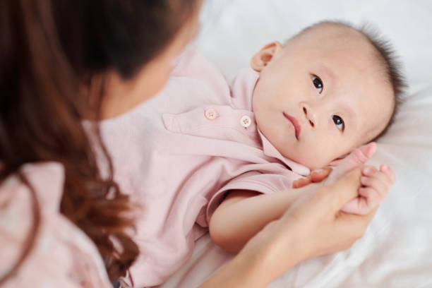 istock Mother touching hand of boy 1257136946