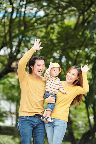 istock Family waving with hands 1257136972