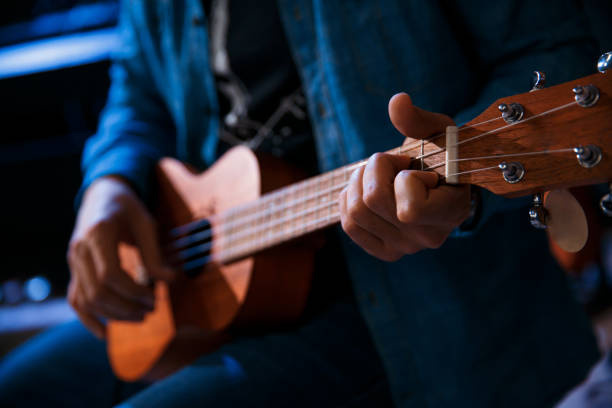istock A young man plays the guitar while sitting 1257138655