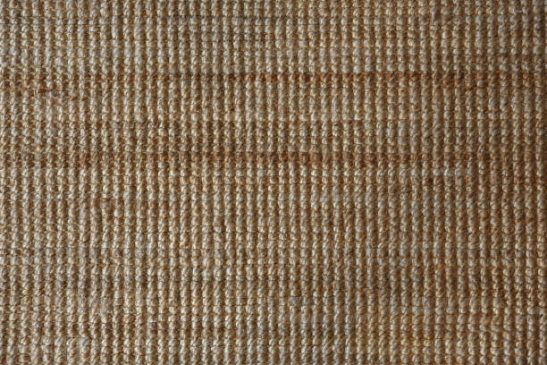 Background and texture of sisal or jute mat Background and texture of a yellow sisal or jute mat, wool camel colored stock pictures, royalty-free photos & images