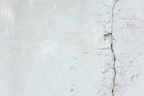 istock Texture and background. White old concrete wall with a crack 1257141440