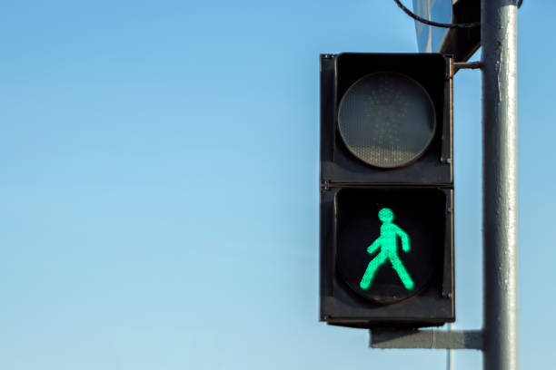 istock green pedestrian traffic light against the sky. 1257142445