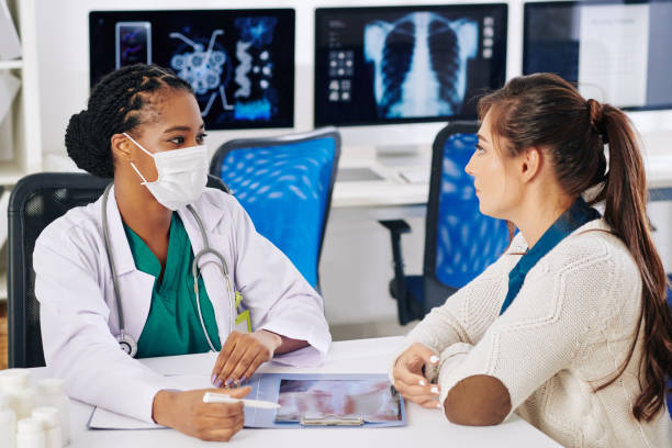 istock Doctor discussing x-ray with patient 1257142901