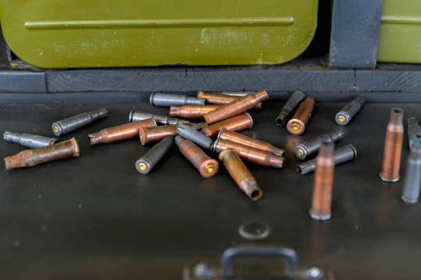 istock Spent copper casings close-up. Empty weapon casings on a dark background. 1257144989