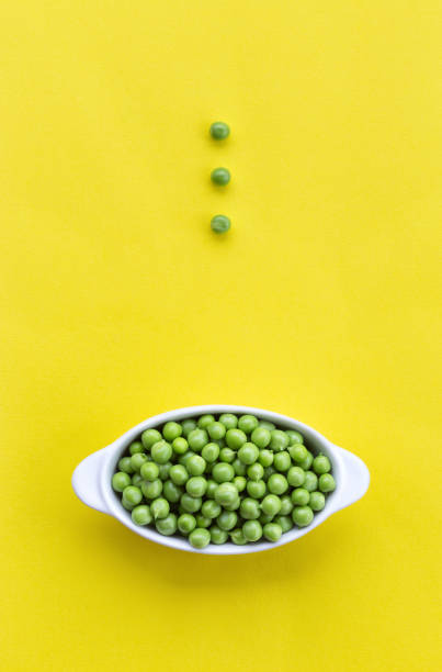 istock Shelled green peas in a white bowl 1257145663