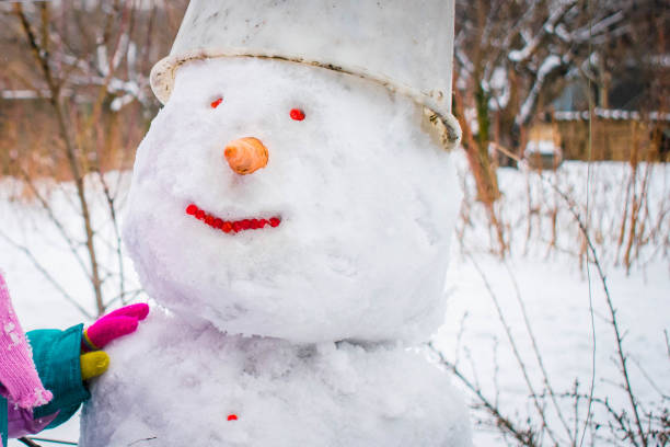 istock Snowman has a bucket on his head and red eyes 1257145740