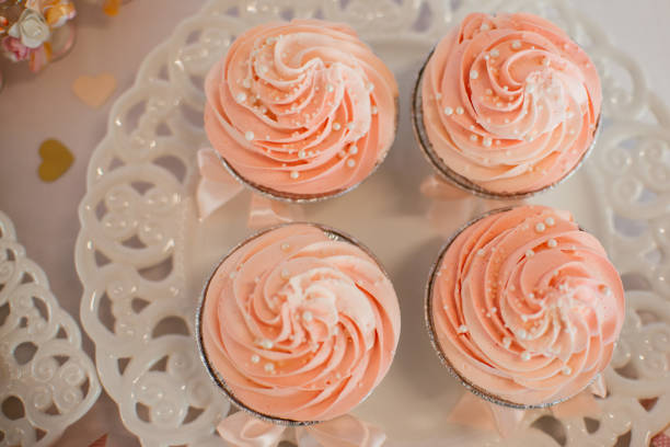 istock Cupcakes with pink frosting on a party table 1257148576