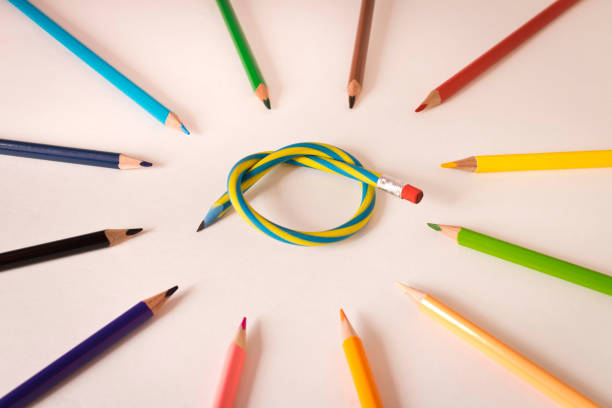 istock Flexible pencil and a set of colored pencils on a light background. Selective focus. 1257149000