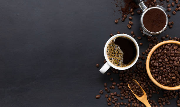 istock hot coffee and bean on black wooden table background. top view 1257150177