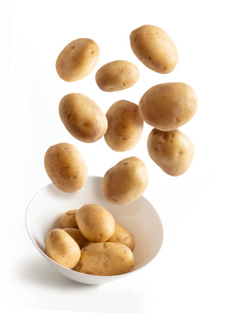 istock Potatoes flying over white bowl, isolated from the background 1257152039
