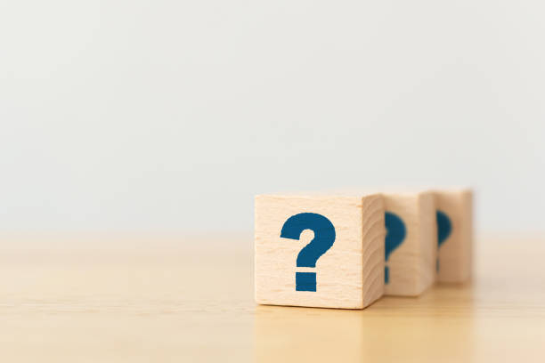 istock Wooden cube block shape with sign question mark symbol on wood table 1257154539