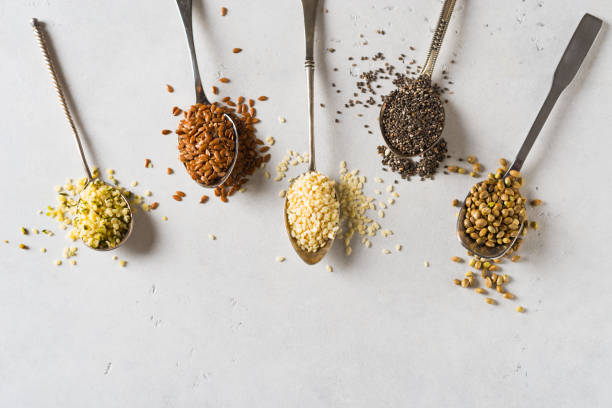 different seeds - hemp, sesame, sunflowers seeds and pumpkin seeds in spoon - hemp seed heap white imagens e fotografias de stock