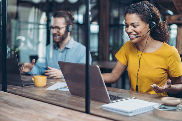 Always accessible customer service Call center professionals working side by side in the office headset stock pictures, royalty-free photos & images