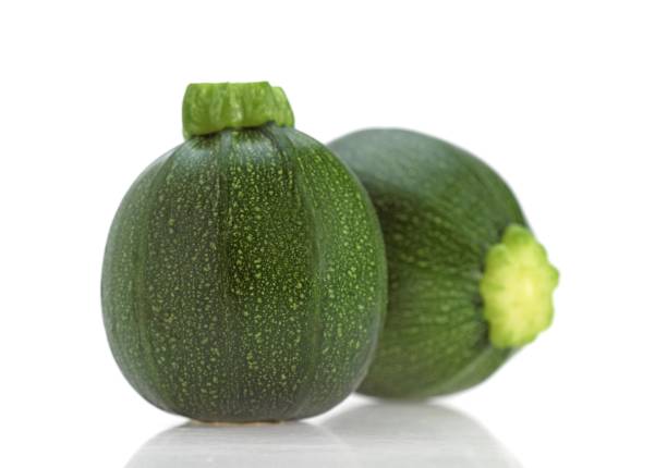 istock Round Courgette or Zucchini, cucurbita pepo against White Background 1257156578