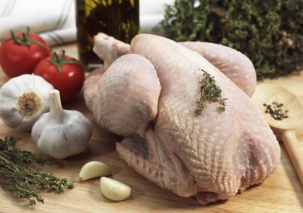 istock Chicken ready to be Cooked with Garlic, Thyme and Tomato 1257157544