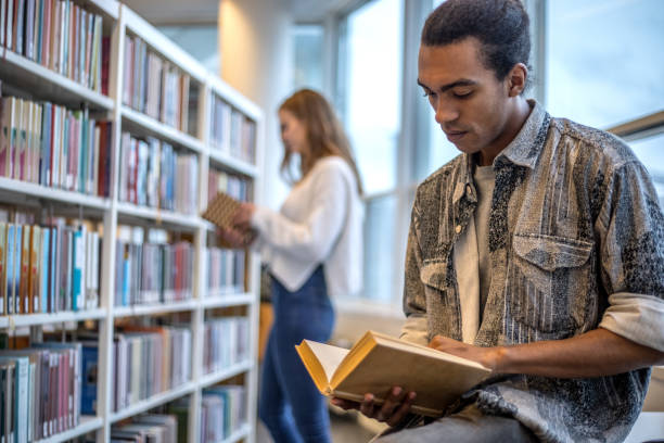 istock Handsome ethnic male university student studying on campus library 1257159088