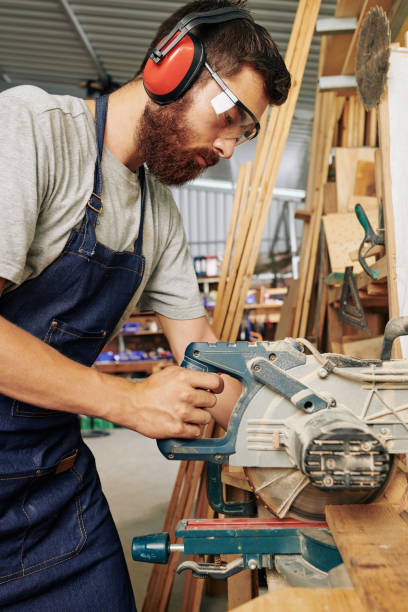 istock Carpenter cutting wooden board 1257159312