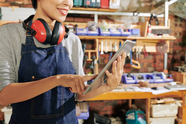 istock Female carpenter with digital tablet 1257159338