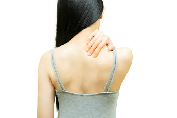Photo of Back of woman in gray undershirt put her hands on the sholder area, nape pain or neck ache, Health-care concept on white background