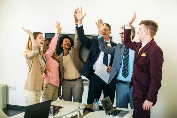 istock Colleagues joining their hands together inside office 1257160233