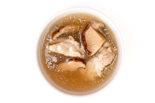 bowl of pork bone and shiitake mushroom soup with herbs isolated on white background. - edible mushroom shiitake mushroom fungus chinese cuisine imagens e fotografias de stock