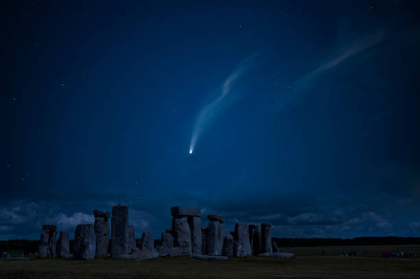 Digital composite image of Neowise Comet over Stonehenge in England Digital composite image of Neowise Comet over Stonehenge burial mound photos stock pictures, royalty-free photos & images