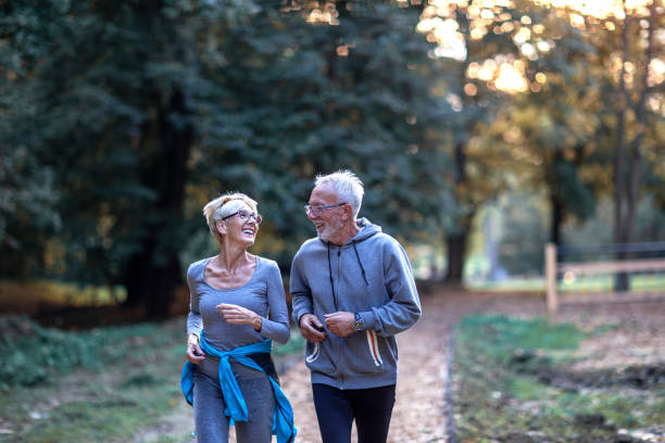 istock Aged couple jogging in the public park and smile 1257163402