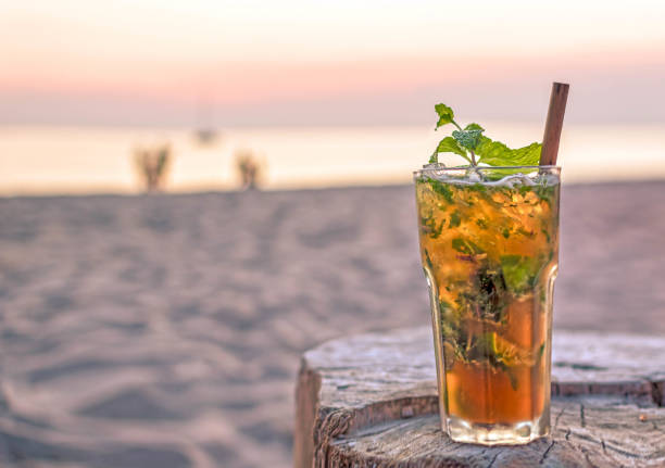 drink with blur beach and sunset in background drink with blur beach and sunset in background goa beach party stock pictures, royalty-free photos & images