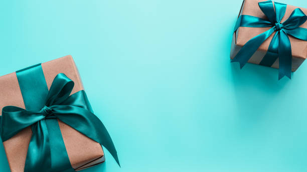 istock Gift boxes in craft paper and satin ribbon, banner 1257165982