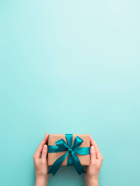 istock Female hands hold gift box, copy space top 1257166572