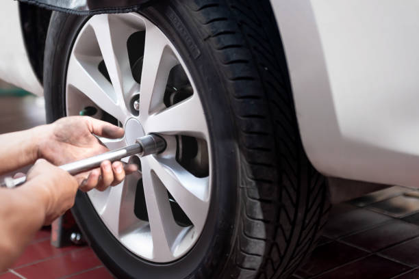 istock Car mechanic with spanner repair the tire 1257167280
