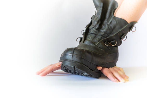 istock Fingers sticking out of a ragged boot 1257168757