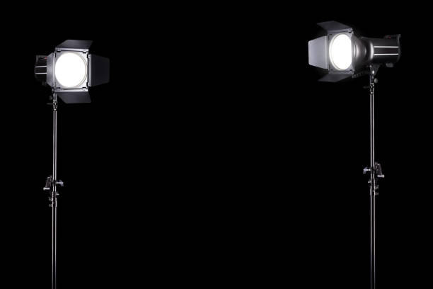 istock Photography studio flash on a lighting stand isolated on black background. 1257169143