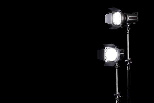 istock Photography studio flash on a lighting stand isolated on black background. 1257169209