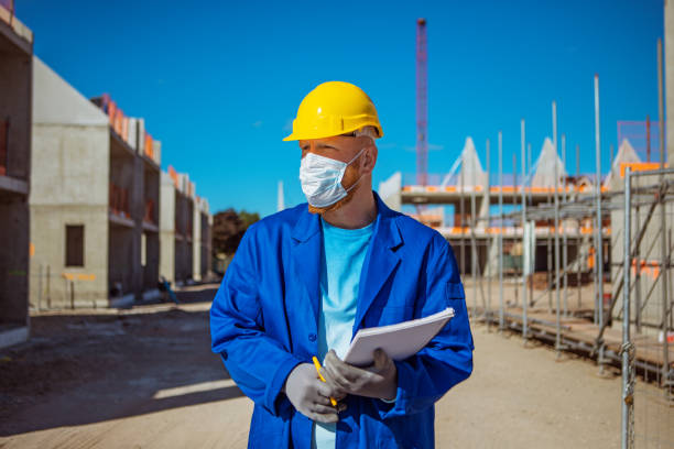 istock A handsome redhead building site foreman wearing a corona mask 1257170116