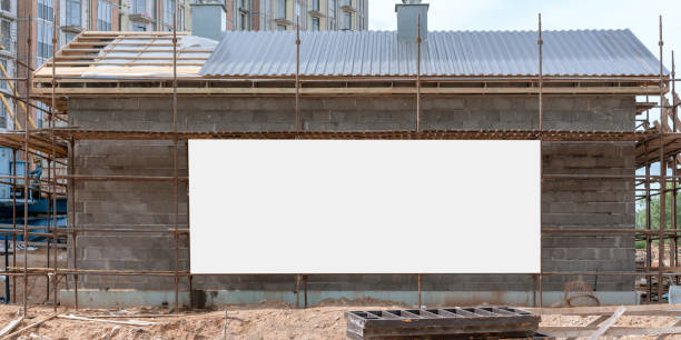 istock large white empty sign board on wall of temporary house on construction site mock-up scaffold background 1257172268
