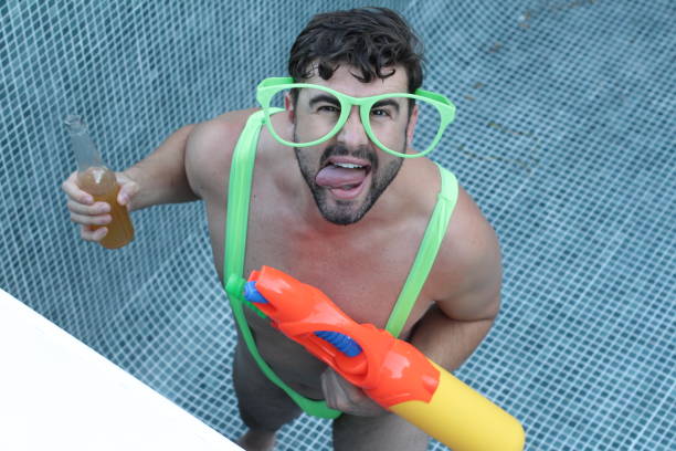 Man wearing hilarious outfit at pool party Man wearing hilarious outfit at pool party. drunk photos stock pictures, royalty-free photos & images