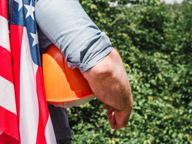 istock Handsome man with tools, holding an American Flag 1257173553