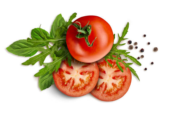 Collage of green leaves of arugula and basil, whole and sliced red tomatoes, black pepper peas are isolated on white. Close up, copy space, top view