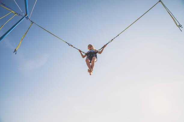 istock child jumping in the jumping attraction worm eye view 1257174922