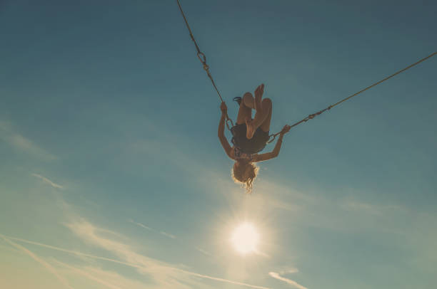 istock active child in bungee jumping trampoline at sunset 1257175002