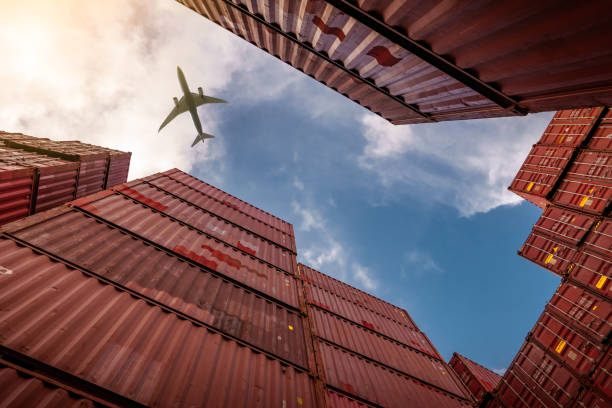 airplane flying above container logistic. cargo and shipping business. container ship for import and export logistic. logistic industry from port to port. container at harbor for truck transport. - travel nautical vessel commercial dock pier imagens e fotografias de stock