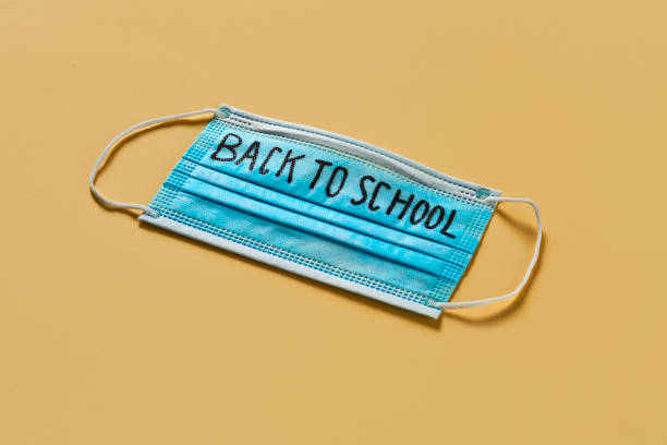 istock surgical mask and text back to school 1257175348