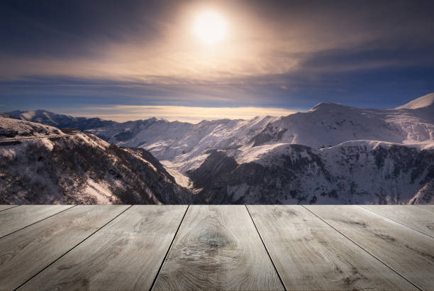 istock Beautiful winter sunset over mountains with empty wooden table. Natural template landscape 1257176663