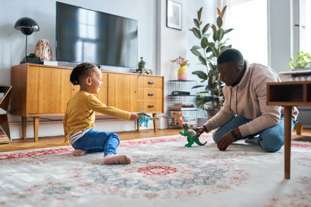 istock Father playing with son at home 1257177751