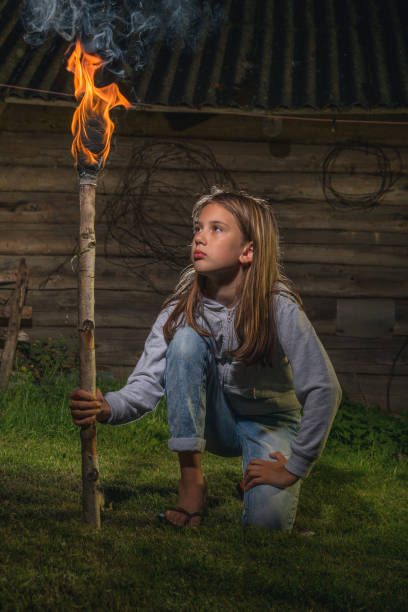 istock A girl with a burning torch. 1257177880