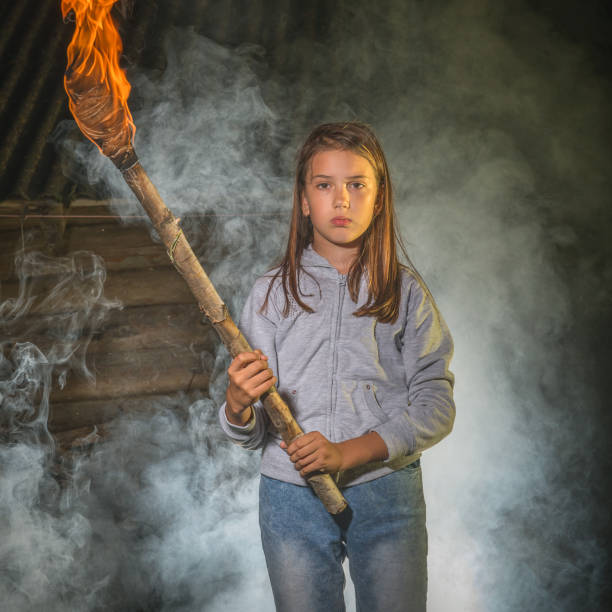 istock A girl with a burning torch. 1257177941