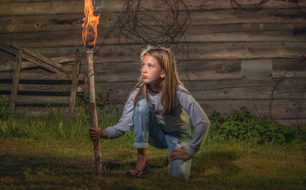 istock A girl with a burning torch. 1257177991